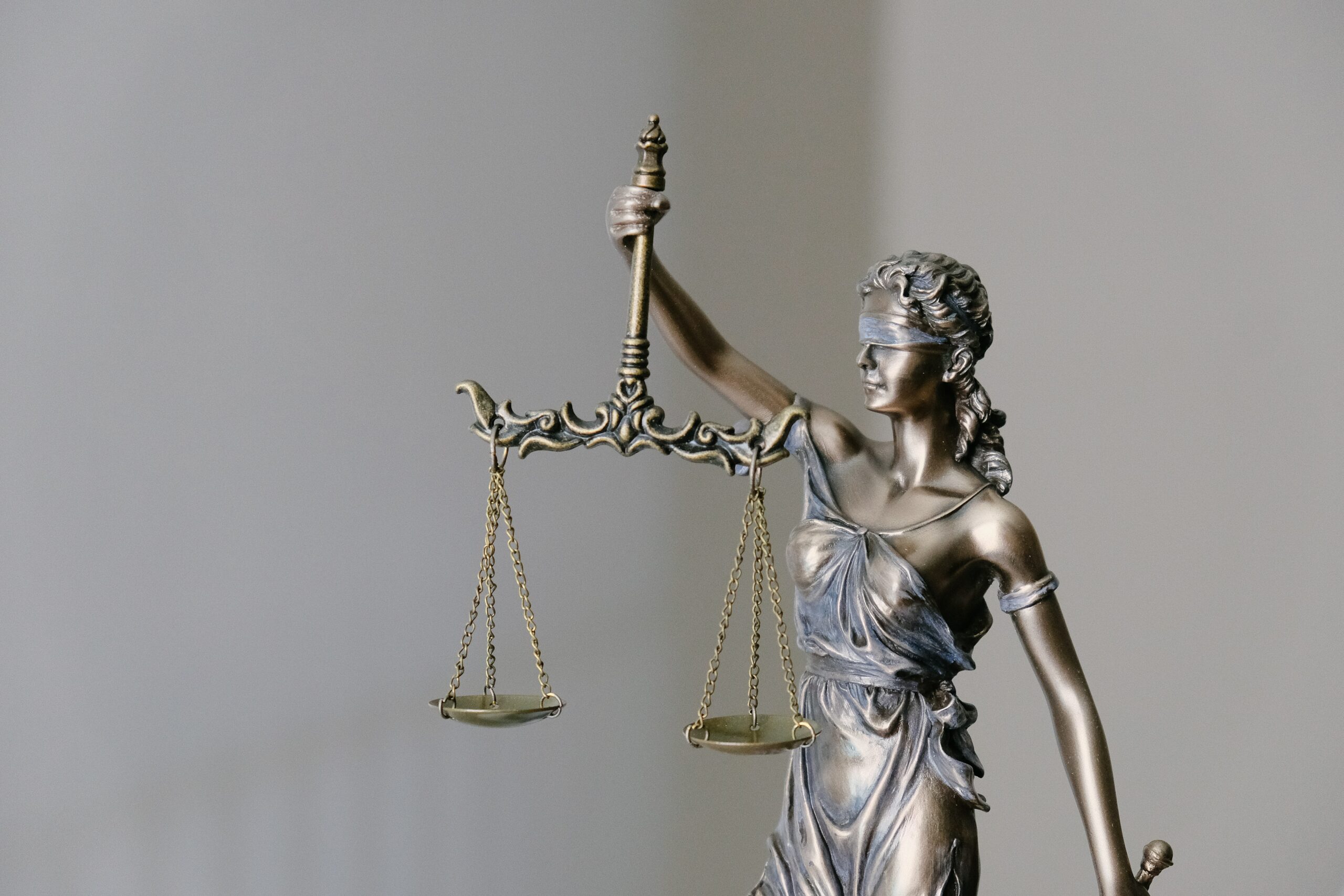 Statue of Lady Justice holding scales. The image represents equity.