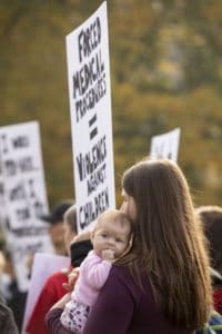 protestors outside the Ontario legislature in Toronto in 2019 supporting a group that announced filing a consistutional challenge against the province's vaccination law.